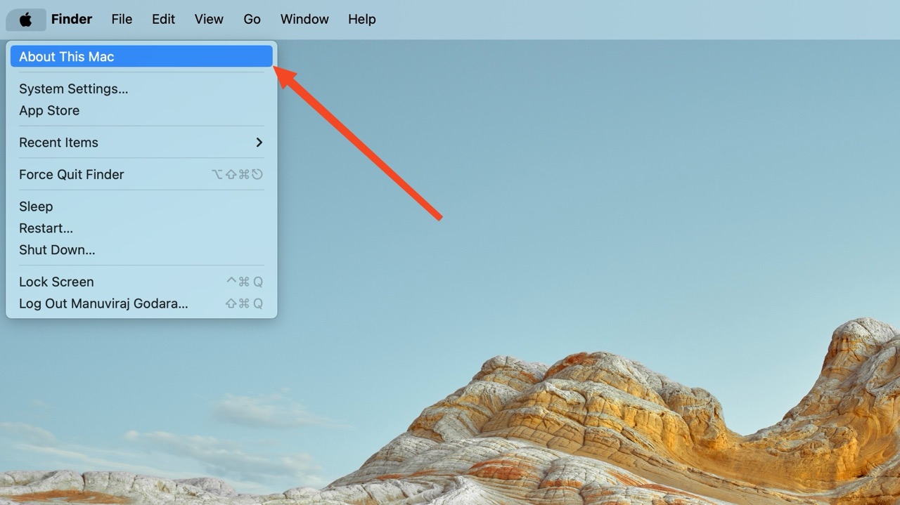 A Finder menu on a Mac with an arrow pointing to the "About This Mac" option.