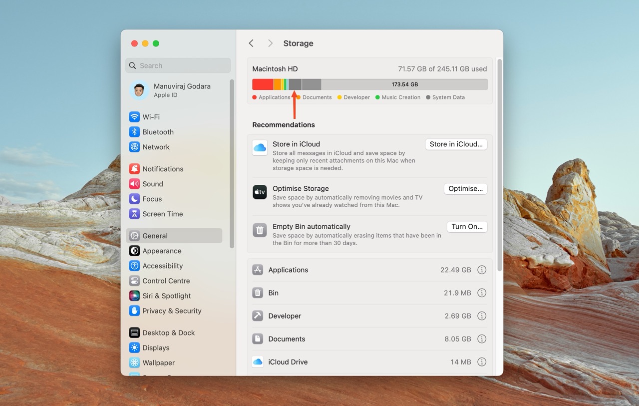 The storage management window on a Mac, displaying the used and available space on Macintosh HD and an arrow pointing to the "System Data" category within the storage breakdown.